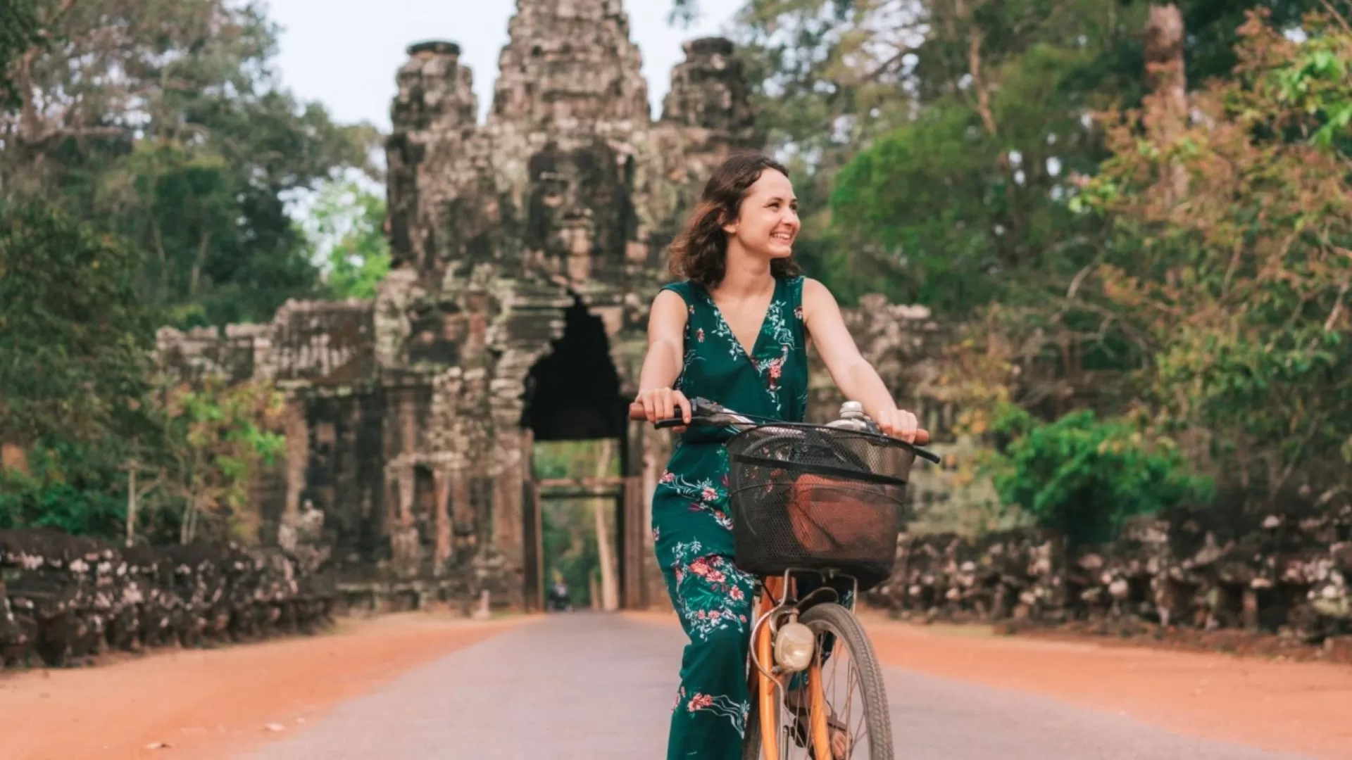 Biking past ancient temple ruins in Cambodia.